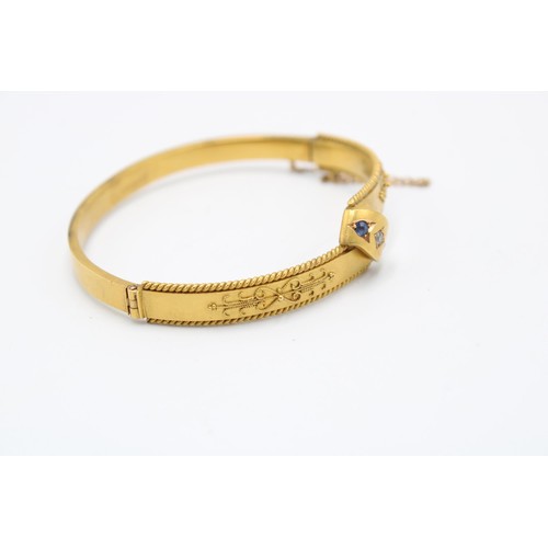 3 - An 15ct 1886 Dated Victorian Diamond & Sapphire Hinged Bangle. Featuring a rope twist border wit... 