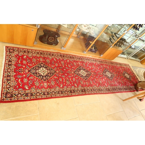 613 - A handmade woollen Kashan runner 3.92m x 1.08m