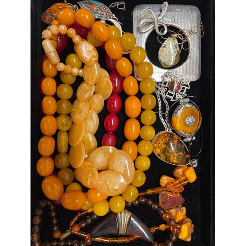  An assortment of amber, silver and costume jewellery.