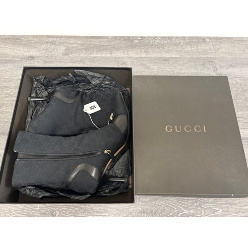  A pair of Gucci 'Ascot' ankle boots, early 2000s, leather trimmed black GG logo canvas with brass fi... 