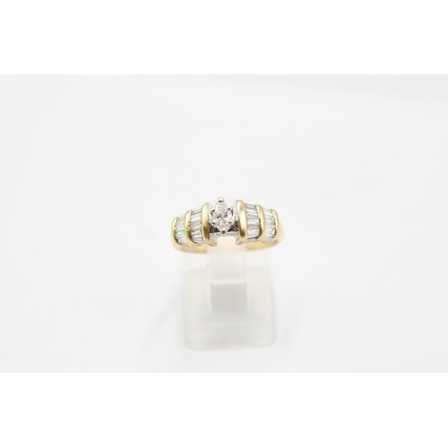 34 - A 14ct Diamond Ring, Featuring a central marquise cut diamond with baguette cut shoulders. Total Dia... 
