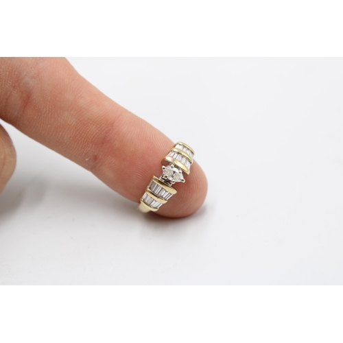 34 - A 14ct Diamond Ring, Featuring a central marquise cut diamond with baguette cut shoulders. Total Dia... 