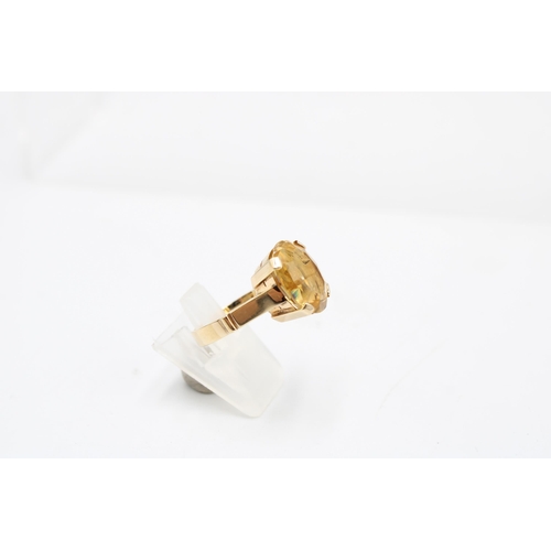  An oval citrine single stone ring. Stamped 585. Size P 1/2. Weight 5.77 grams