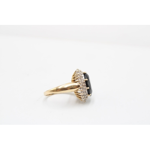  An oval sapphire and diamond cluster ring. Stamped 14KT. Size O. Weight 5.99 grams