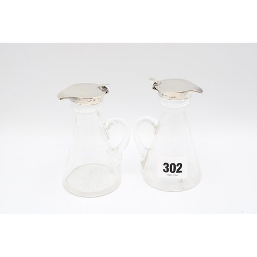 302 - A pair of silver-mounted glass whisky noggins, S&nbsp;Blanckensee & Son, Birmingham, 1916, heigh... 