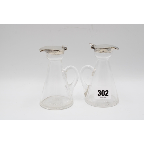 302 - A pair of silver-mounted glass whisky noggins, S&nbsp;Blanckensee & Son, Birmingham, 1916, heigh... 