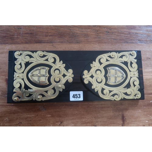453 - A coromandel and brass book slide, probably late 19th century, the ends mounted with shields within ... 