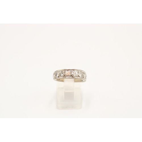A brilliant cut diamond nine stone band ring. Estimated total weight 1.95cts, G/H colour, I1/I2 clarity. Stamped 18ct. Size L. Weight 5.58 grams.