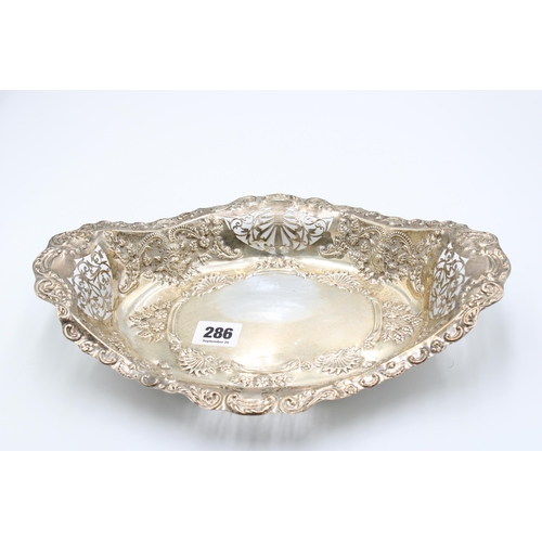  A silver basket, apparently unmarked but tested as sterling silver, chased with scrolls, flowers and... 