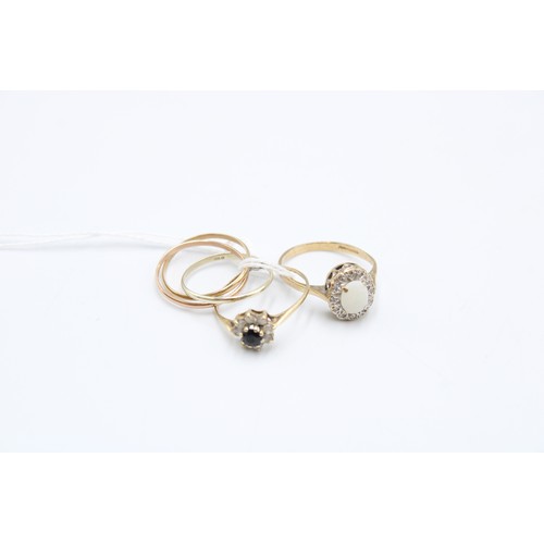  Three 9ct gold rings, one set with an opal within diamonds, size M/N, one set with a round-cut sapph... 