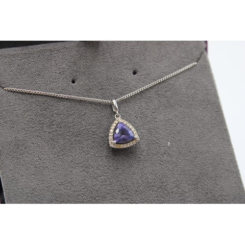  An 18ct white gold, tanzanite and diamond necklace and pendant, struck 750, length of chain 46cm, gr... 