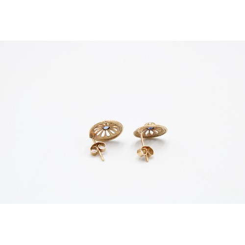  A pair of 9ct gold and sapphire earrings, the circular cut stones within an open rosette frame, appa... 