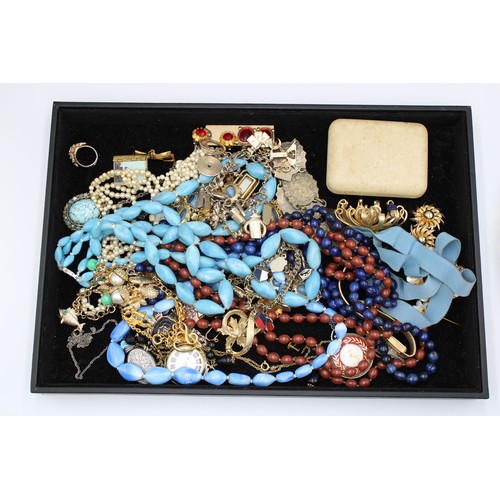  A group of costume jewellery, comprising bead necklaces, base metal charm bracelets, brooches, and a... 