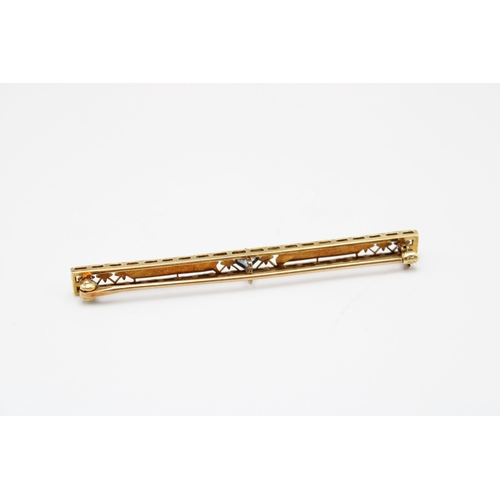 66 - An Art Deco 14ct gold and sapphire brooch, the pierced bar of flowers, trellis and engine-turned pan... 
