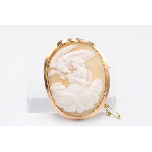 80 - A 9ct rose gold and shell cameo brooch, 19th century, carved with Hebe feeding Zeus' eagle, struck 9... 