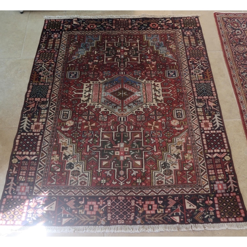 580 - A hand knotted woollen Heriz rug - 1.65m x 1.32m