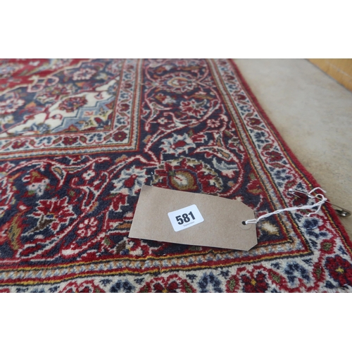 581 - A hand knotted woollen Kashan rug - 2.18m x 1.35m
