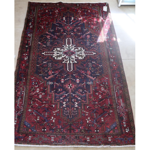 582 - A hand knotted woollen Heriz rug - 2.14m x 1.35m