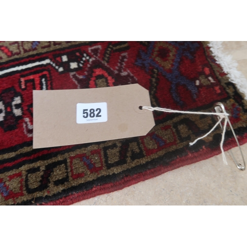 582 - A hand knotted woollen Heriz rug - 2.14m x 1.35m