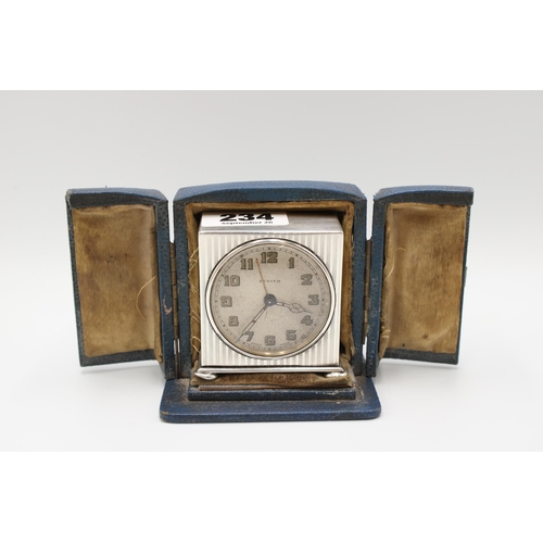 234 - A silver Zenith travelling alarm clock, the case George Neal & George Neal, London, 1922, height... 