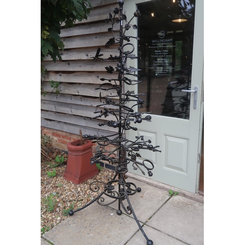 650 - An ornate bronzed wine bottle holder, decorated with foliage, grape and vine, frogs, dragonfly 178cm... 