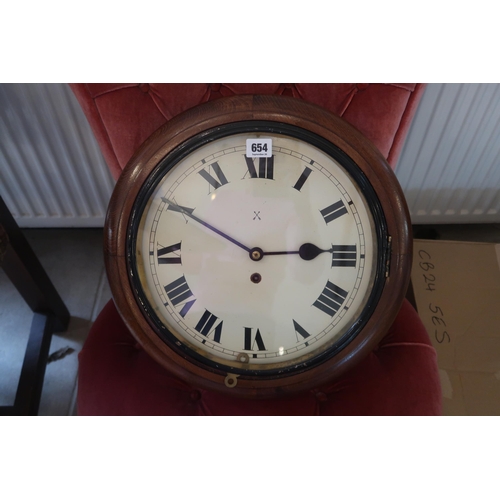 654 - A wall clock, late 19th or early 20th century, with key, diameter 41cm