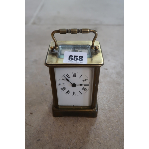 658 - A vintage brass and glass carriage clock, white enamel face, with key, height of case 11cm