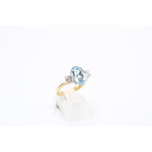  An 18ct gold oval aquamarine and brilliant cut diamond three stone ring. Size P. Weight 4.64 gramsCo... 