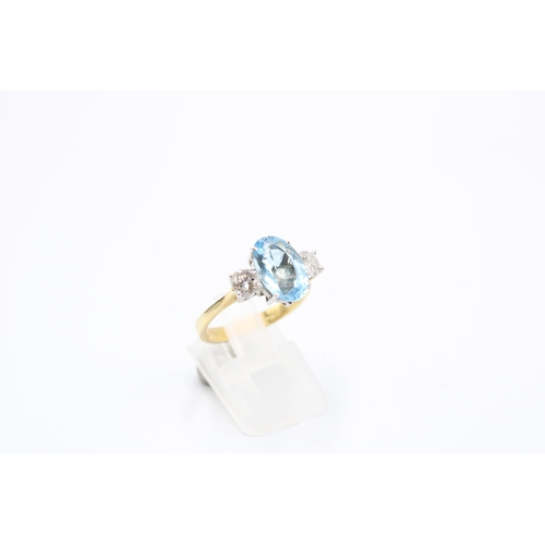  An 18ct gold oval aquamarine and brilliant cut diamond three stone ring. Size P. Weight 4.64 gramsCo... 