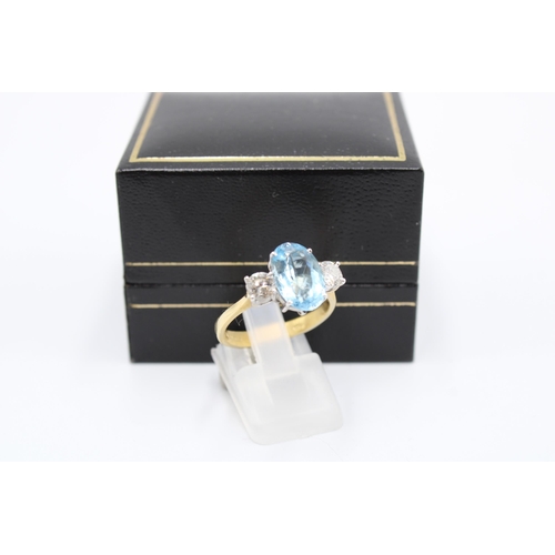  An 18ct gold oval aquamarine and brilliant cut diamond three stone ring. Size P. Weight 4.64 gramsCo... 