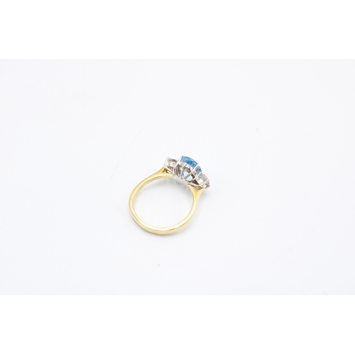  An 18ct gold oval aquamarine and brilliant cut diamond three stone ring. Size P. Weight 4.64 gramsCo... 