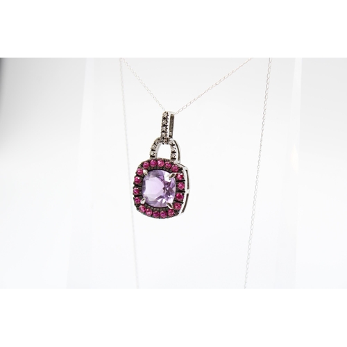  An amethyst, ruby (possibly synthetic) and diamond cluster pendant. Length of pendant 26mm, length o... 