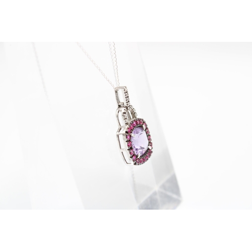  An amethyst, ruby (possibly synthetic) and diamond cluster pendant. Length of pendant 26mm, length o... 