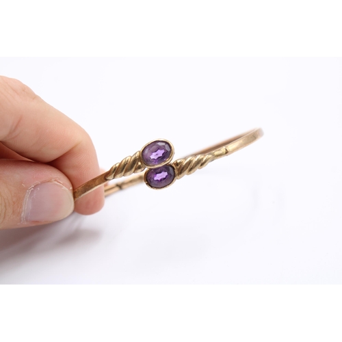 An amethyst cross over rolled gold bangle. Weight 7.41 gramsCondition: Fair - misshaped, with dents ... 