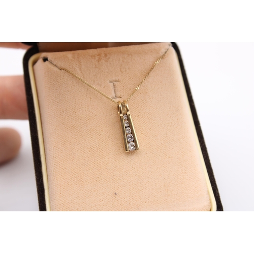  A cubic zirconia graduated line pendant. Stamped 375. Length of pendant 16mm, length of chain 460mm ... 