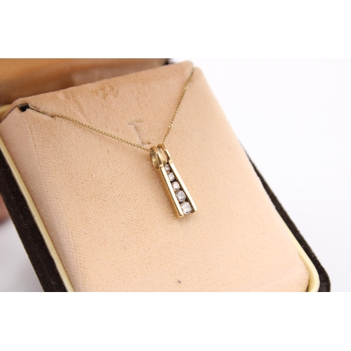  A cubic zirconia graduated line pendant. Stamped 375. Length of pendant 16mm, length of chain 460mm ... 