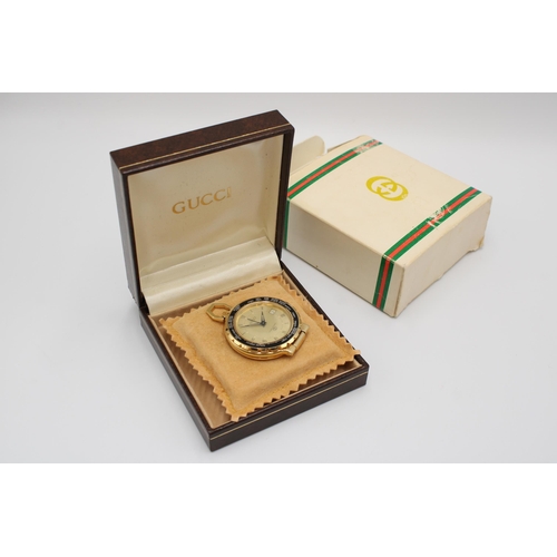  A Vintage Gucci Travel 'World Time' Pocket Watch featuring a rotating black bezel marked with variou... 