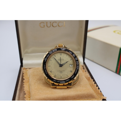  A Vintage Gucci Travel 'World Time' Pocket Watch featuring a rotating black bezel marked with variou... 