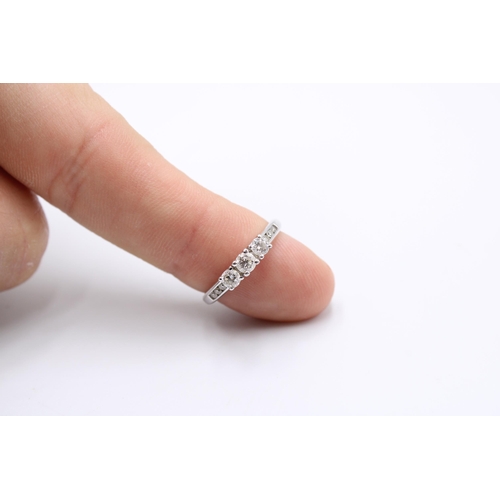  A 9ct Diamond Three Stone Ring, Three Central 3mm Diamonds with Chanel Set Shoulders.&nbsp;Weight: 2... 