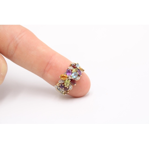  A 9ct gold and multicoloured gem-set ring, the stones set as three flowerheads within diamonds, stru... 