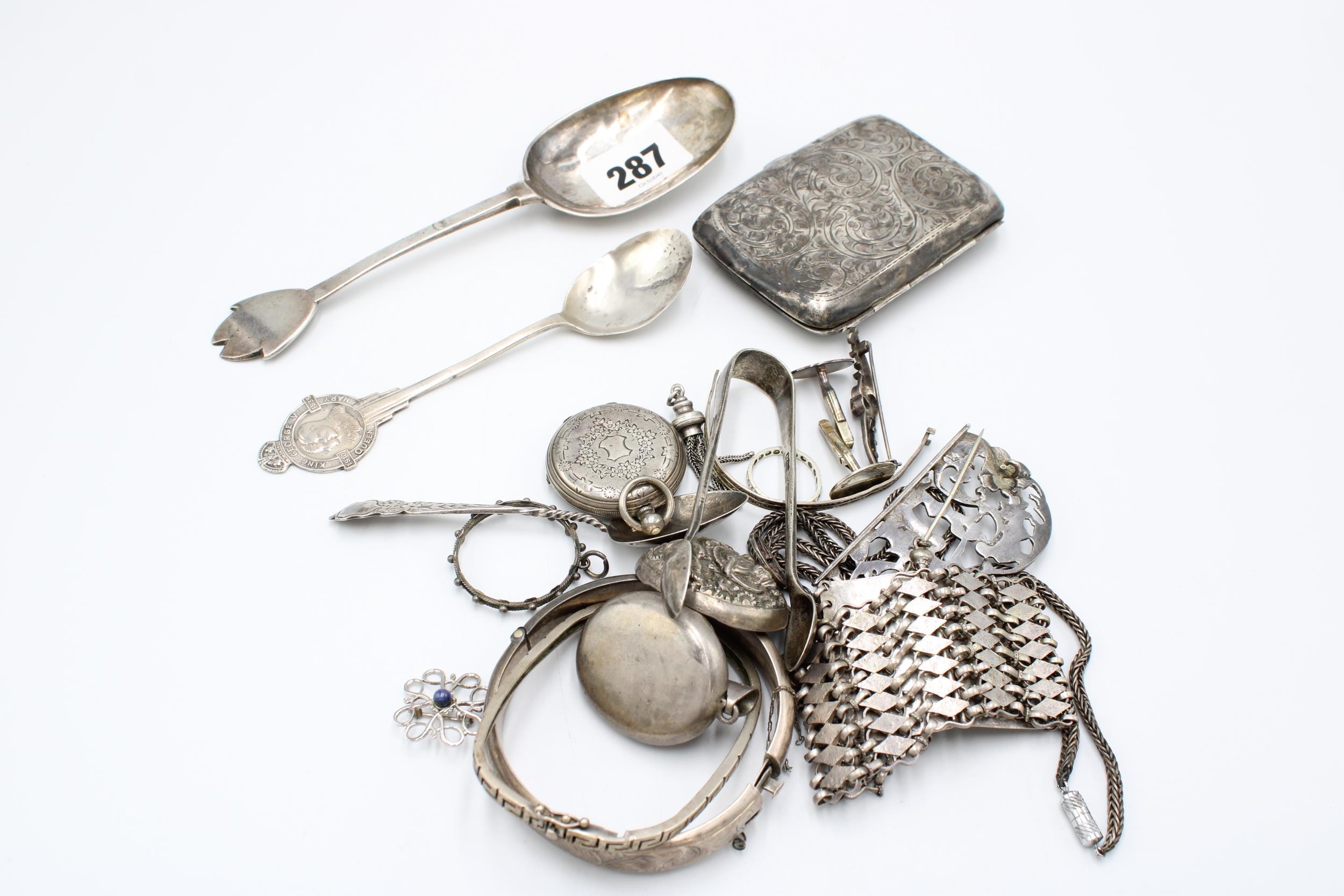 A group of silver and white metal objects, including a trefid pattern ...