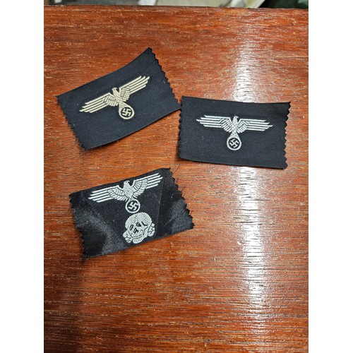 561 - 3 WWII German SS Cloth Cap and Sleeve Eagles