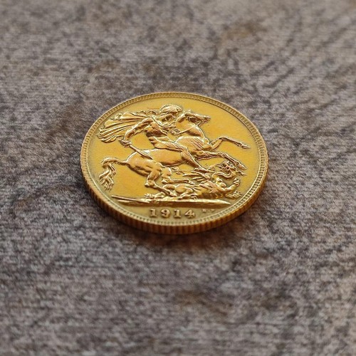 140 - 1914 George V Gold Sovereign Coin: 22 carat gold British coin featuring St. George and Dragon revers... 