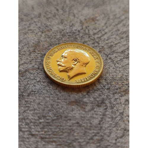 140 - 1914 George V Gold Sovereign Coin: 22 carat gold British coin featuring St. George and Dragon revers... 