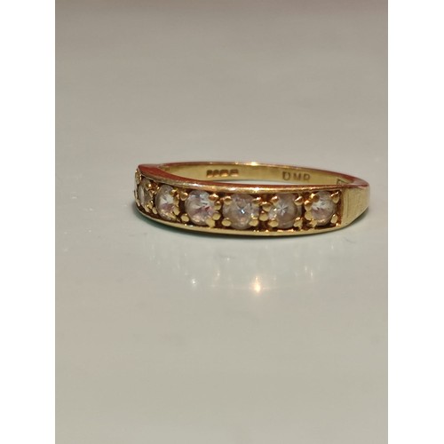 156 - 18ct gold ring adorned with seven diamonds. Size R and 2.8grams gross. Stamped with London hallmark ... 