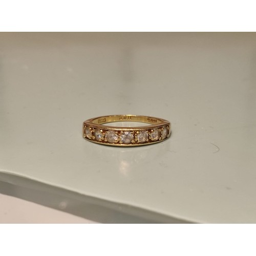 156 - 18ct gold ring adorned with seven diamonds. Size R and 2.8grams gross. Stamped with London hallmark ... 