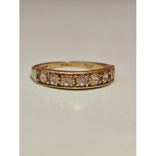 156 - 18ct gold ring adorned with seven diamonds. Size R and 2.8grams gross. Stamped with London hallmark ... 