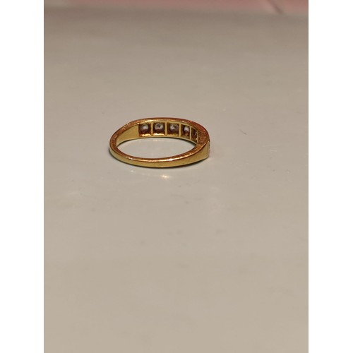 156 - 18ct gold ring adorned with seven diamonds. Size R and 2.8grams gross. Stamped with London hallmark ... 