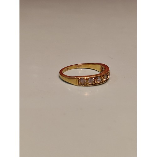 156 - 18ct gold ring adorned with seven diamonds. Size R and 2.8grams gross. Stamped with London hallmark ... 