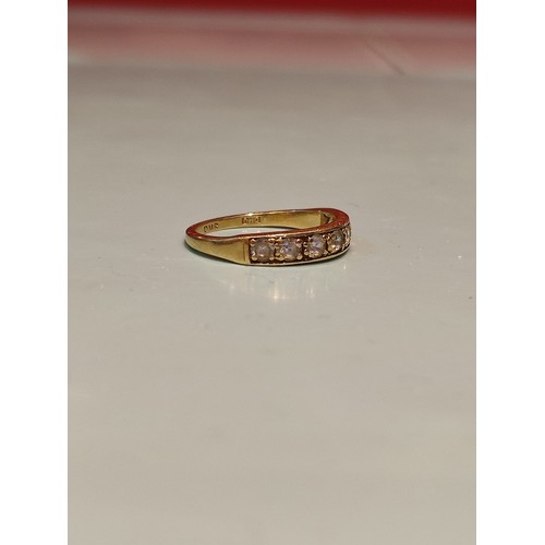 156 - 18ct gold ring adorned with seven diamonds. Size R and 2.8grams gross. Stamped with London hallmark ... 